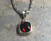Sterling Silver Pendant with One Cushion Cut Garnet on a Handwoven Ste