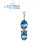 Sterling Silver Rhodium Plated Pendant with Two Oval Cut Blue Topazes.