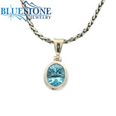 Small Sterling Silver Pendant with an Oval Cut Blue Topaz Gemstone. Pe