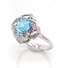 KALEIDOSCOPE 14 Karat White Gold Rig with one 6.5mm Round Blue Topaz, Emeralds & Rubies