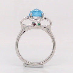 KALEIDOSCOPE 14 Karat White Gold Rig with one 6.5mm Round Blue Topaz, Emeralds & Rubies
