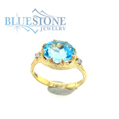 14 Karat Yellow Gold Ring with Blue Topaz gemstone and 2 Round Diamond