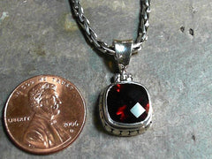 Sterling Silver Pendant with One Cushion Cut Garnet on a Handwoven Ste