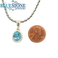 Small Sterling Silver Pendant with an Oval Cut Blue Topaz Gemstone. Pe