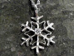 Sterling Silver Snowflake Pendant With One Round Cubic Zirconium.
Com